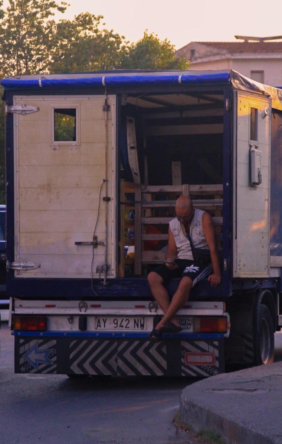 A box truck with its back open on a street